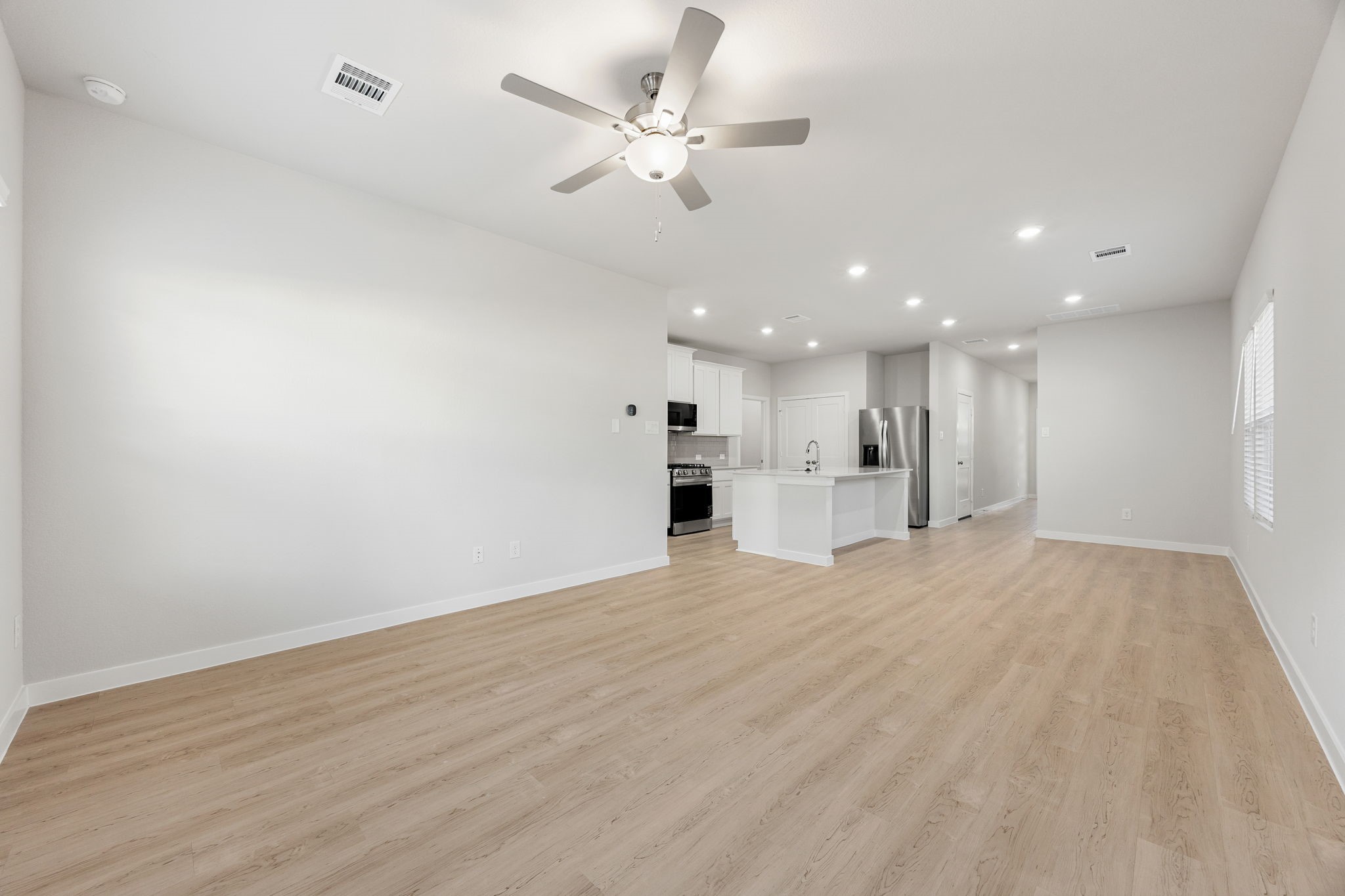 302 Brazen Forest Trail Magnolia, TX 77354 - Photo 15 of 22 a view of an empty room with a kitchen