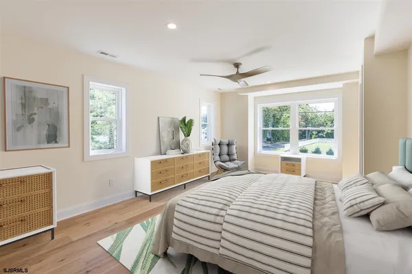 a bedroom with a large bed and a large window