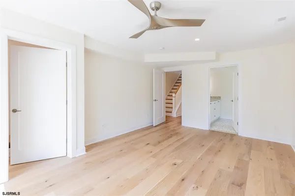 an empty room with closet and a bathroom