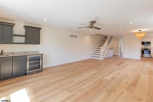 a view of a kitchen with microwave and a sink