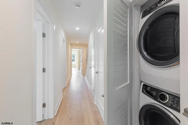 a view of a hallway with washer and dryer