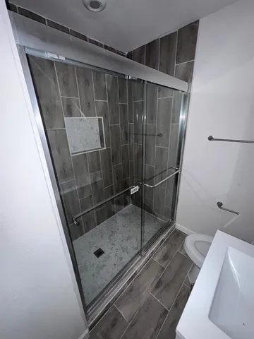 a bathroom with a glass shower door