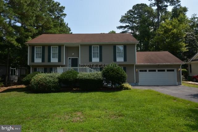 12 Mist Flower Road Ocean Pines, MD 21811 - Photo 1 of 42 a front view of a house with a garden and plants