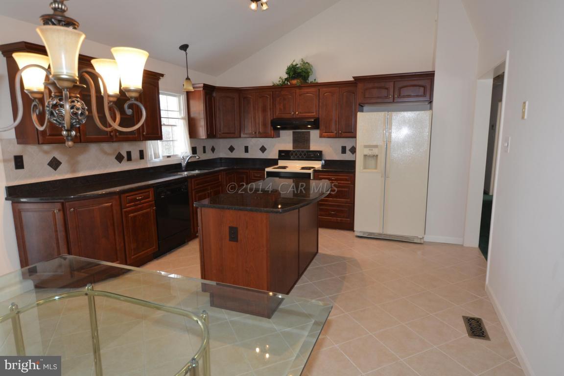 12 Mist Flower Road Ocean Pines, MD 21811 - Photo 15 of 42 a kitchen with stainless steel appliances granite countertop a stove a sink and a refrigerator