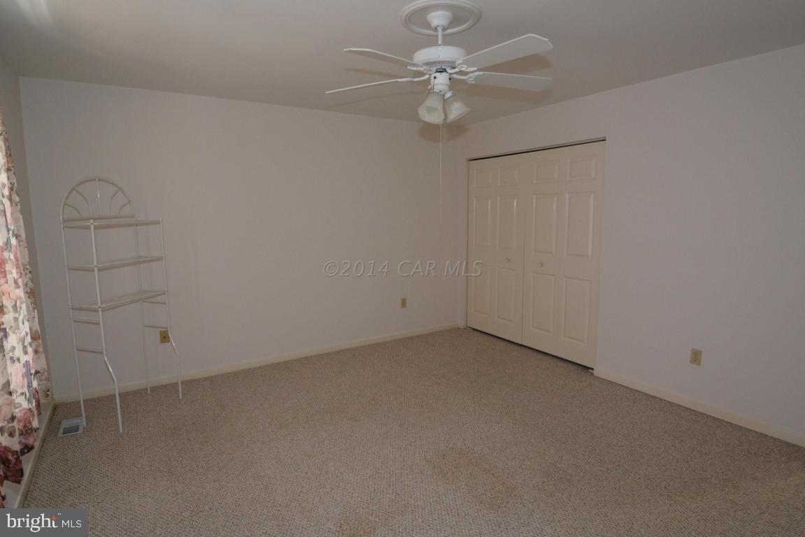 12 Mist Flower Road Ocean Pines, MD 21811 - Photo 22 of 42 an empty room with a ceiling fan and a window