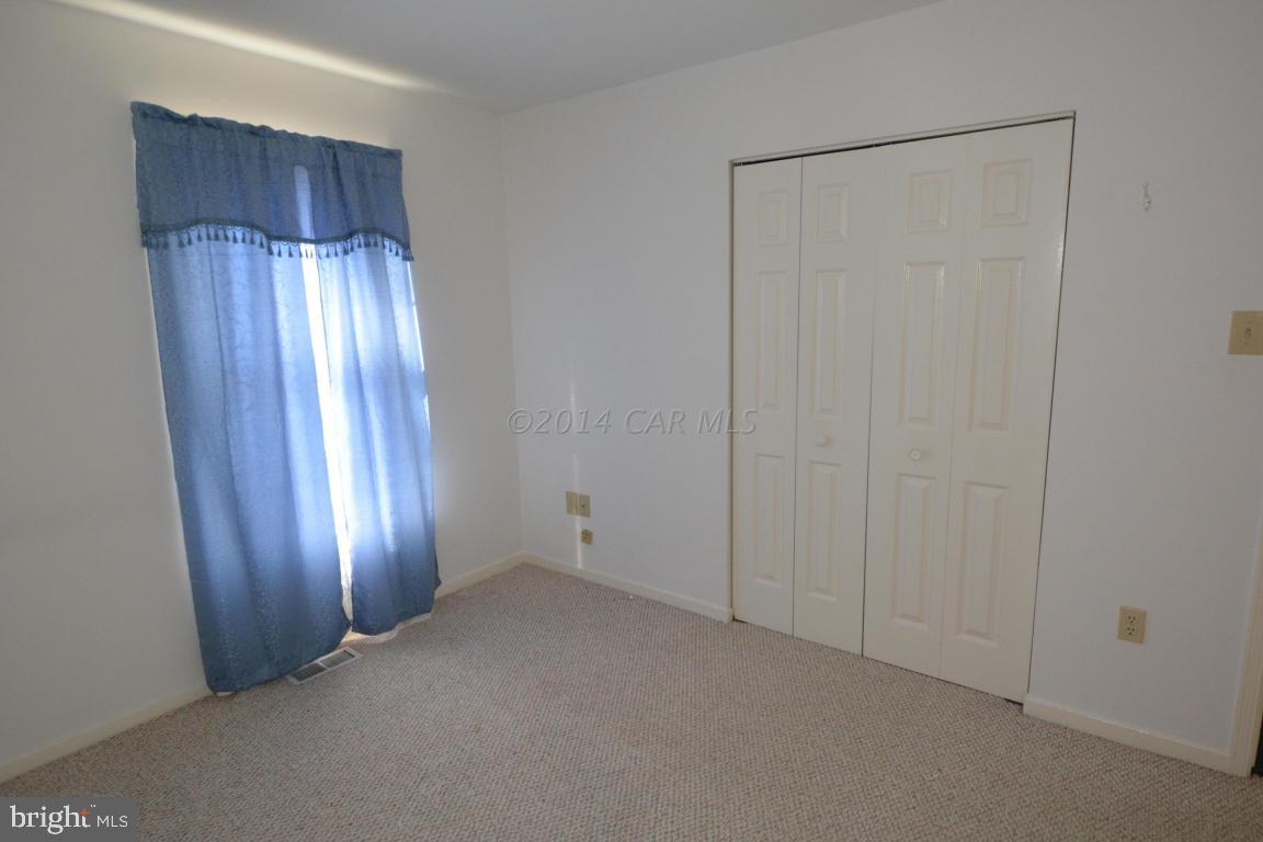 12 Mist Flower Road Ocean Pines, MD 21811 - Photo 32 of 42 a view of an empty room with wooden door and wooden floor