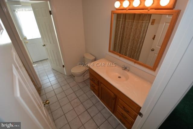12 Mist Flower Road Ocean Pines, MD 21811 - Photo 8 of 42 a bathroom with a sink a toilet and a mirror