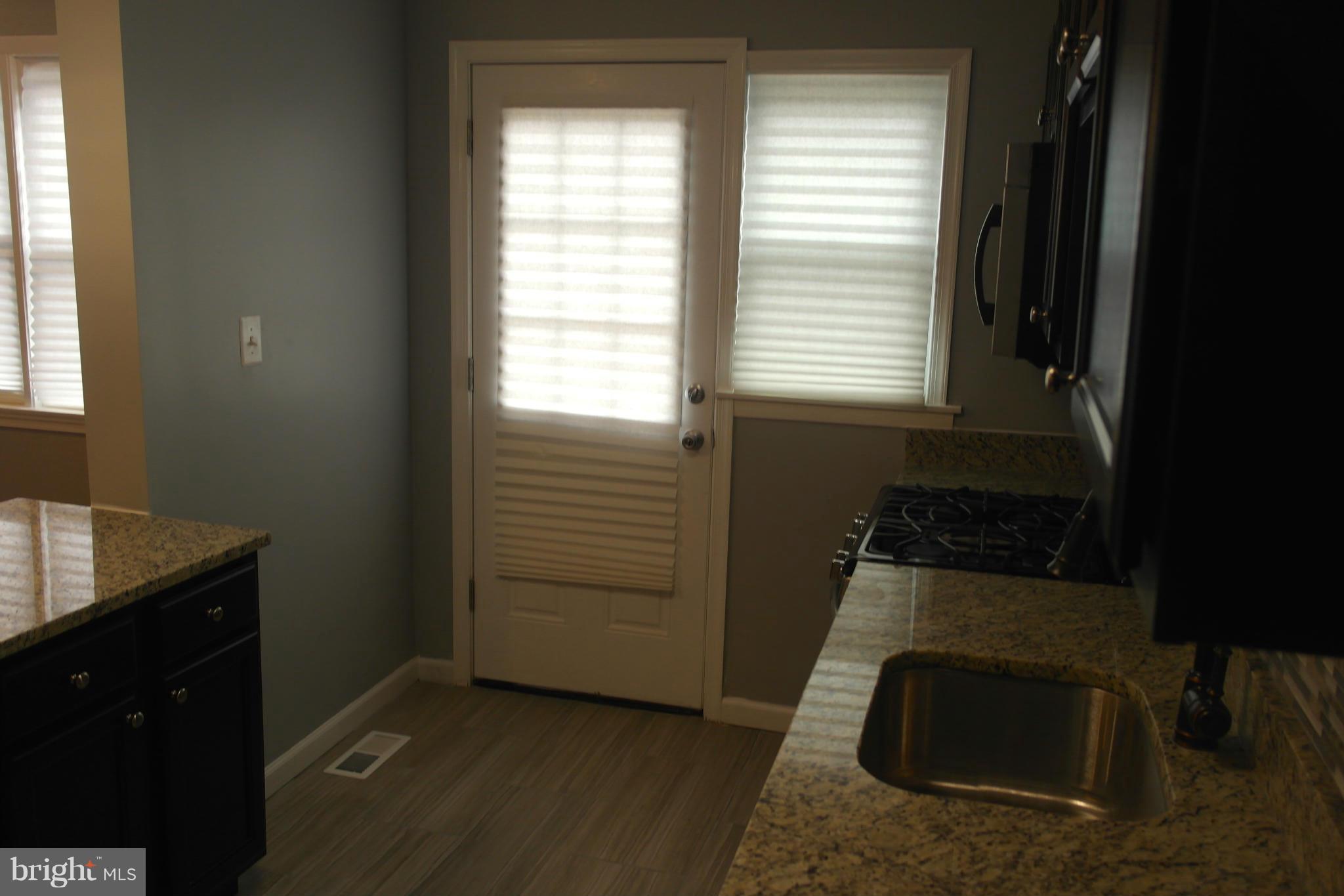 1225 Wicklow Road Baltimore, MD 21229 - Photo 4 of 17 a bathroom with a sink and a window
