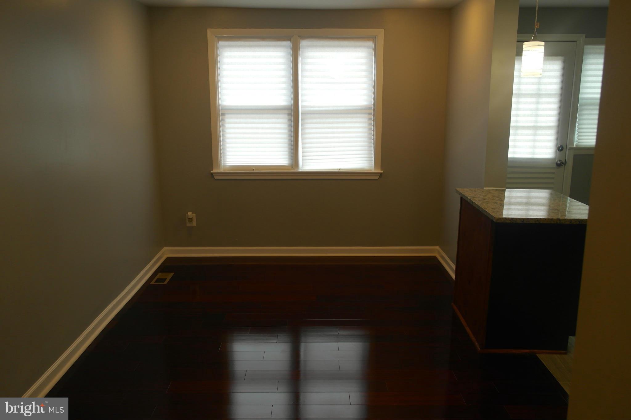 1225 Wicklow Road Baltimore, MD 21229 - Photo 6 of 17 a view of a room with wooden floor and a window