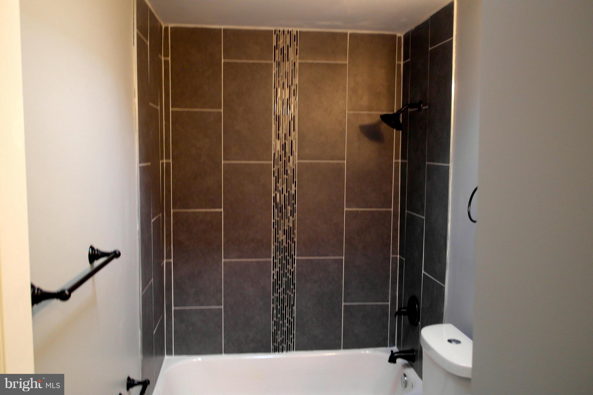 1225 Wicklow Road Baltimore, MD 21229 - Photo 8 of 17 a bathroom with a shower and a toilet