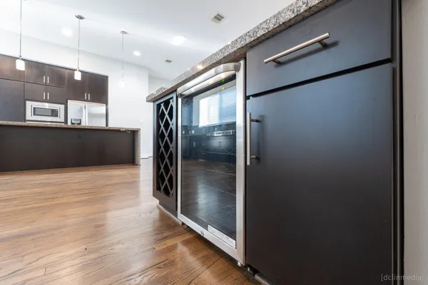 a view of a refrigerator in kitchen and wooden floor