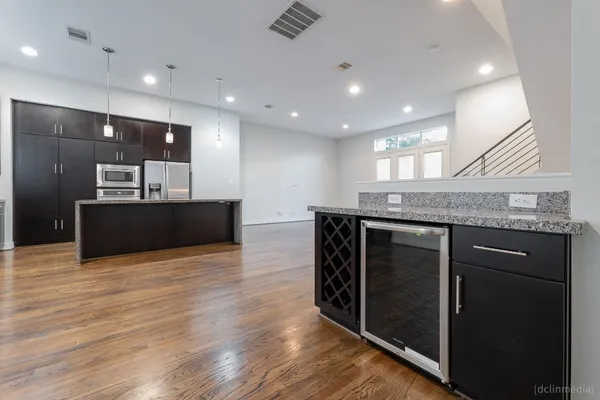a kitchen with stainless steel appliances granite countertop a kitchen island a cabinets and wooden floor