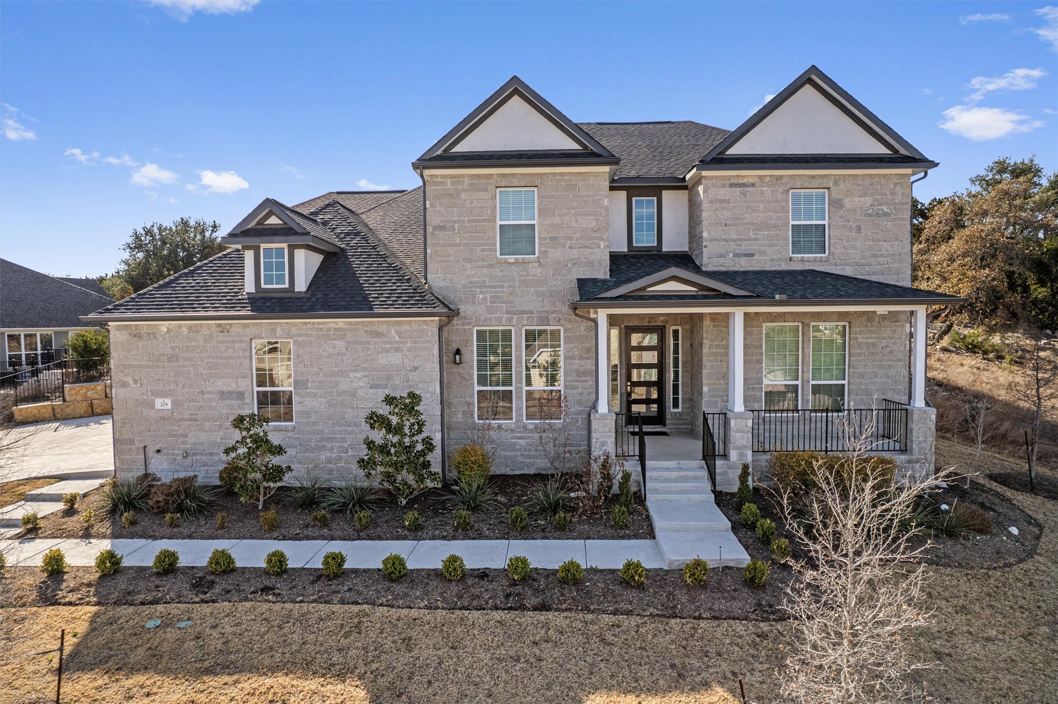 View of front of home featuring a porch and stone siding