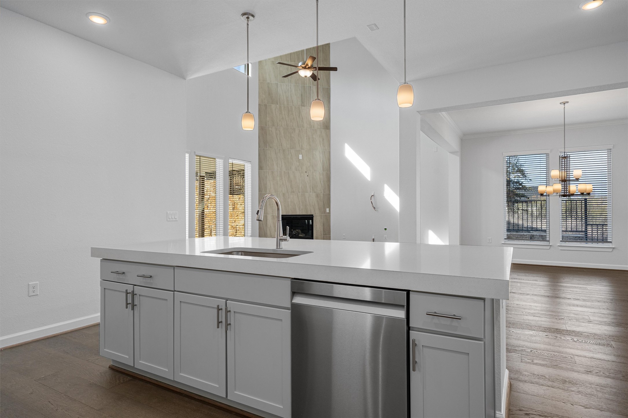 208 Lodestone Lane Austin, TX 78738 - Photo 36 of 38 Kitchen with stainless steel dishwasher, an island with sink, dark wood finished floors, open floor plan, and ceiling fan