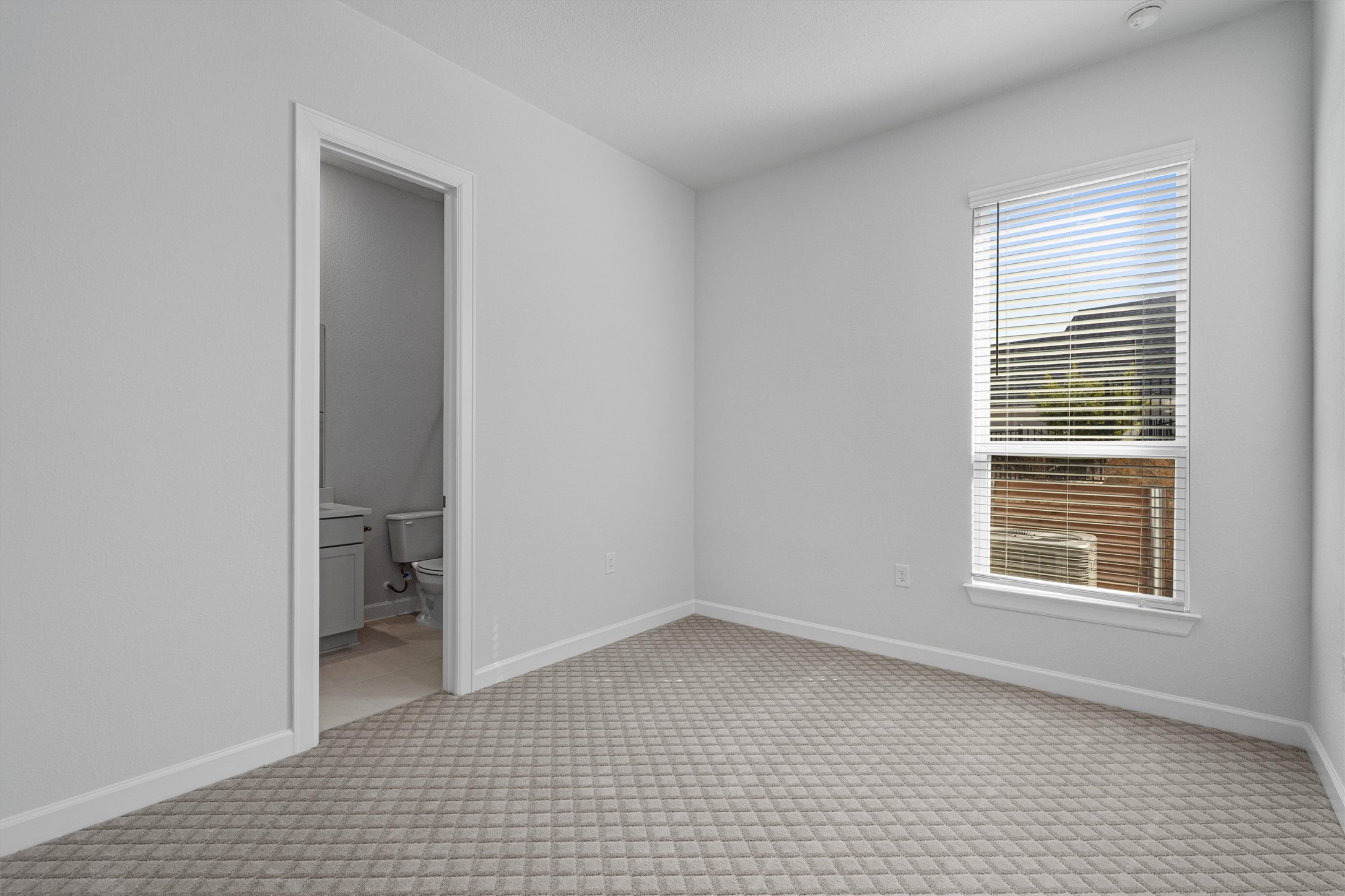 208 Lodestone Lane Austin, TX 78738 - Photo 16 of 38 Unfurnished bedroom featuring light colored carpet and connected bathroom