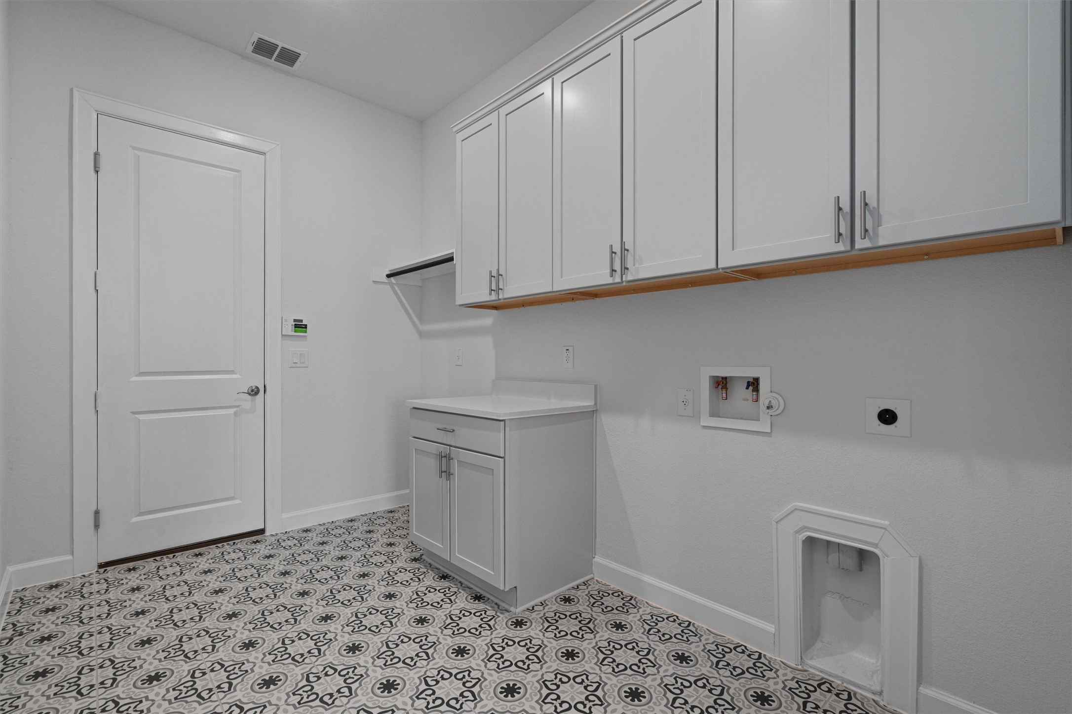 208 Lodestone Lane Austin, TX 78738 - Photo 18 of 38 Laundry room featuring hookup for a washing machine, electric dryer hookup, and cabinet space