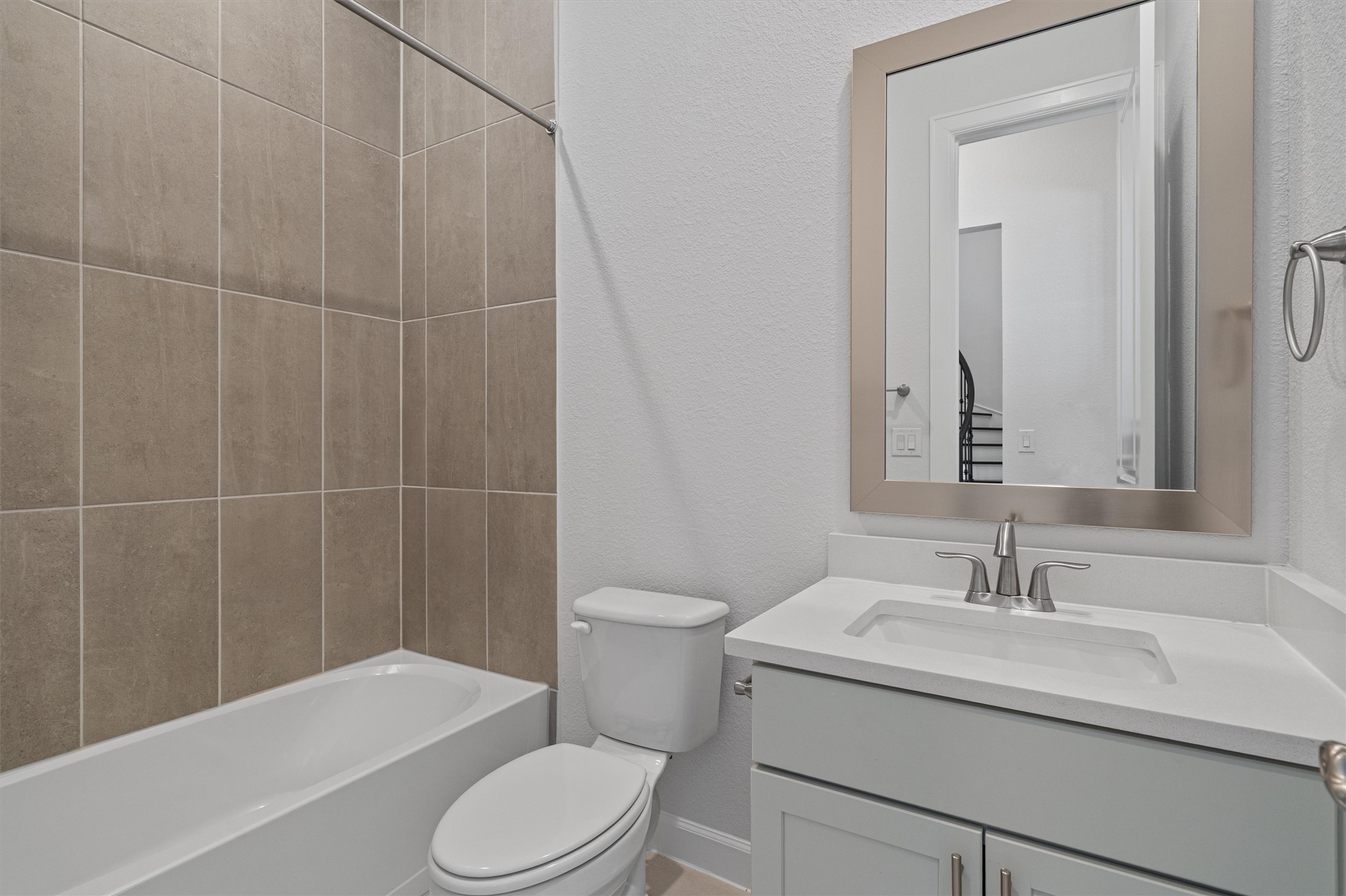 208 Lodestone Lane Austin, TX 78738 - Photo 21 of 38 Bathroom featuring a textured wall, vanity, and bathing tub / shower combination