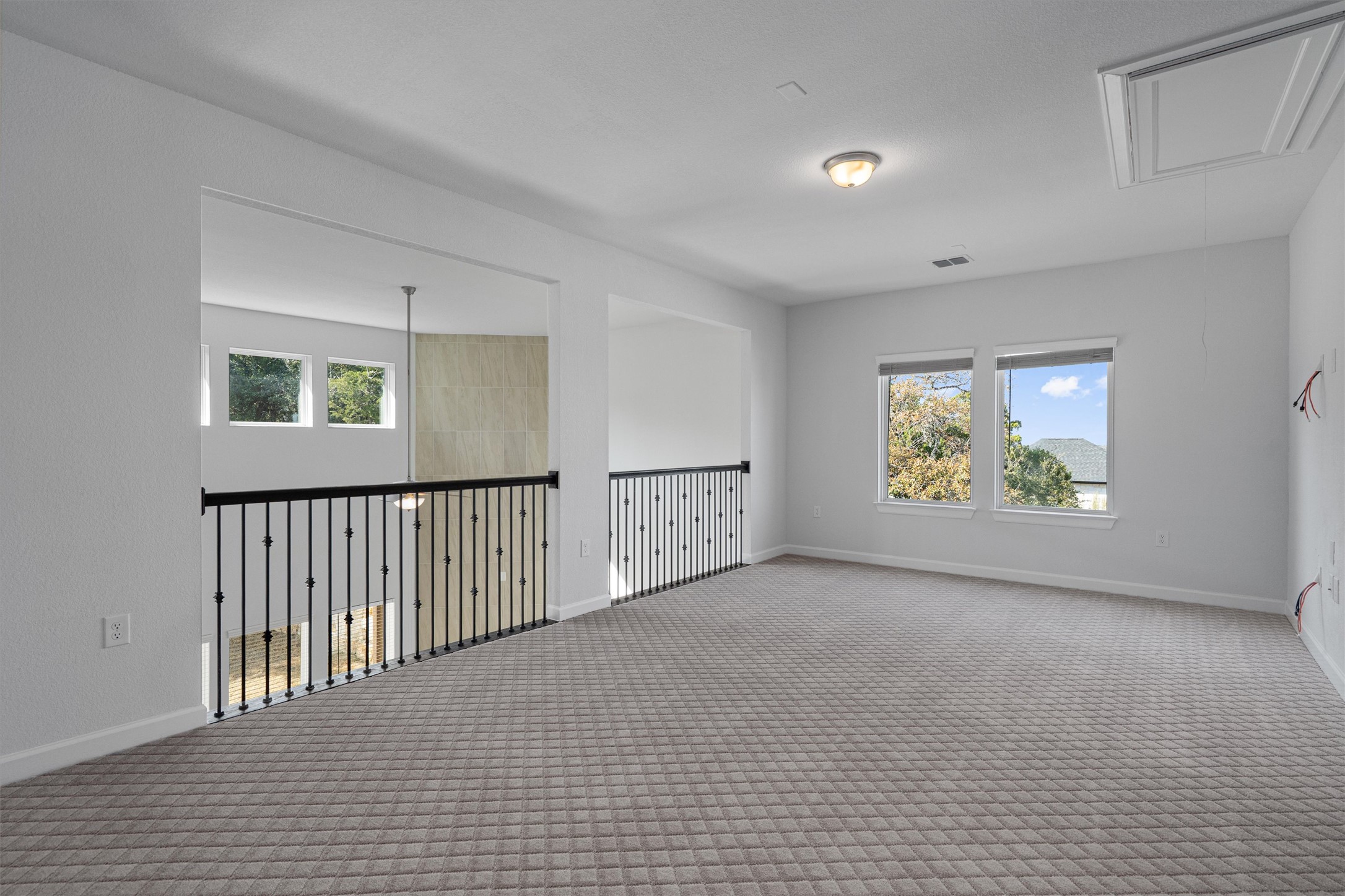 208 Lodestone Lane Austin, TX 78738 - Photo 23 of 38 Carpeted spare room with attic access and baseboards