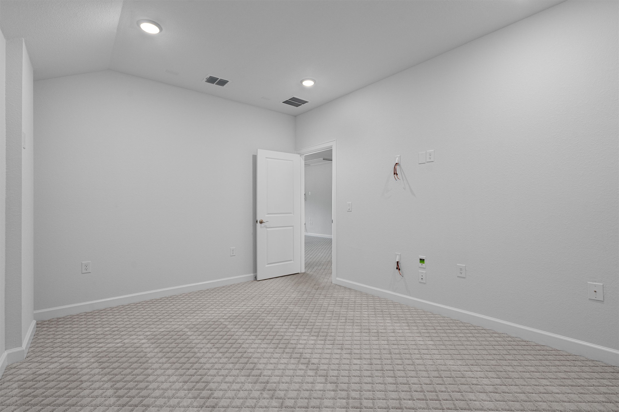 208 Lodestone Lane Austin, TX 78738 - Photo 25 of 38 Empty room with light carpet, lofted ceiling, and recessed lighting