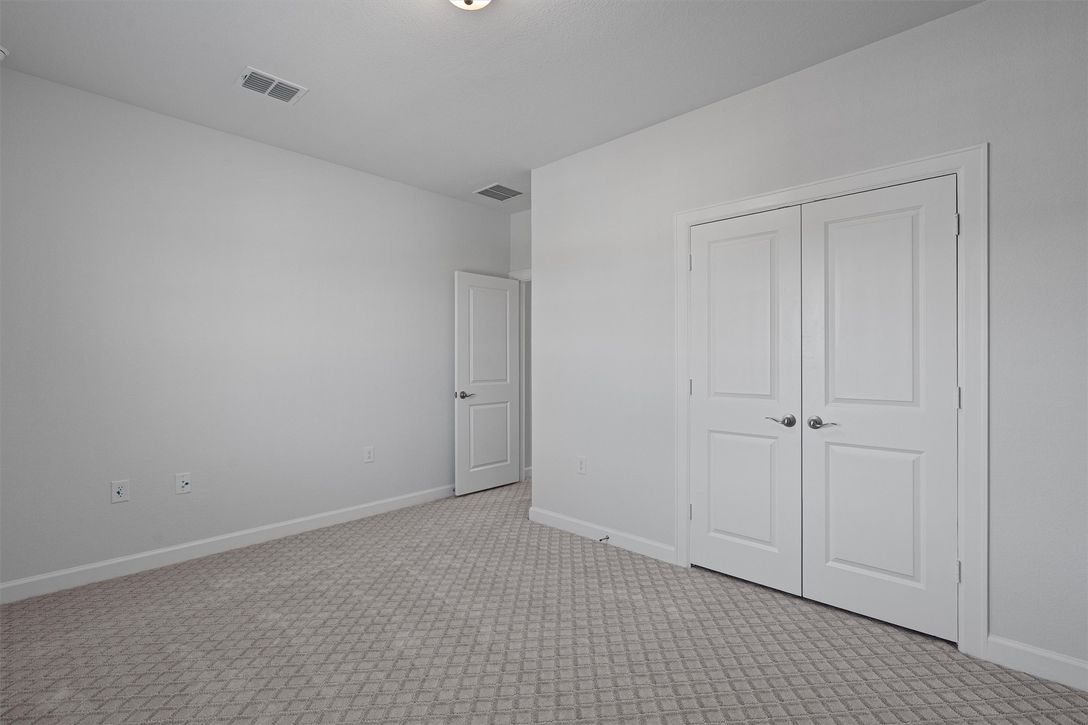 208 Lodestone Lane Austin, TX 78738 - Photo 26 of 38 Unfurnished bedroom featuring light colored carpet and a closet