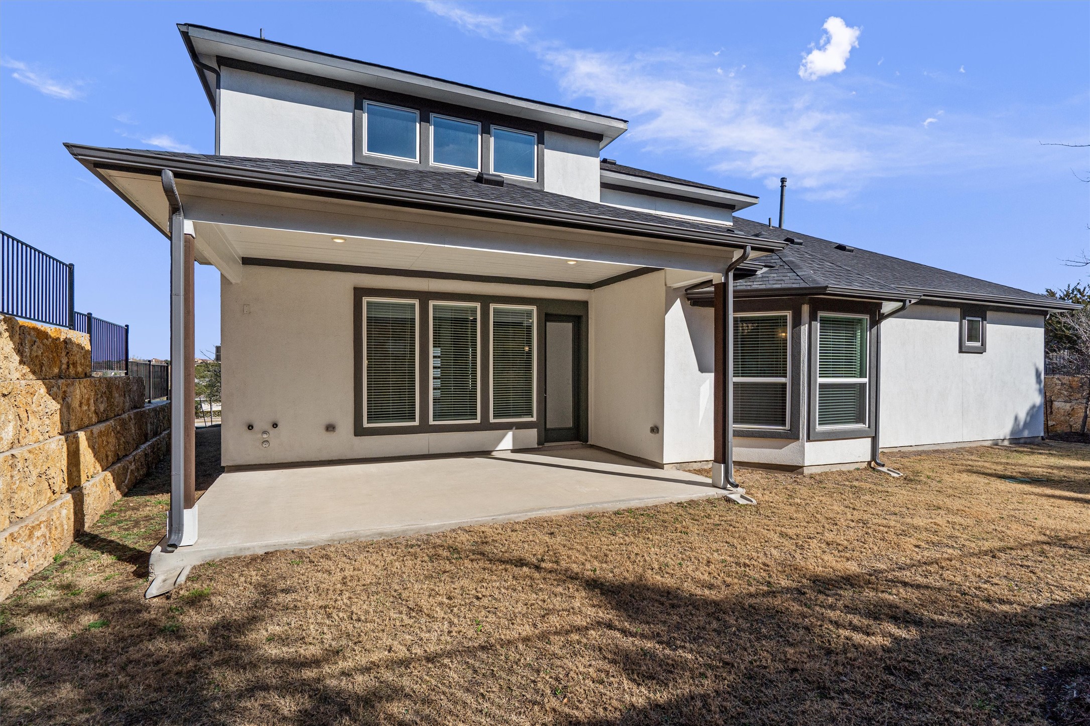 208 Lodestone Lane Austin, TX 78738 - Photo 32 of 38 Rear view of property featuring a patio area, a yard, and stucco siding