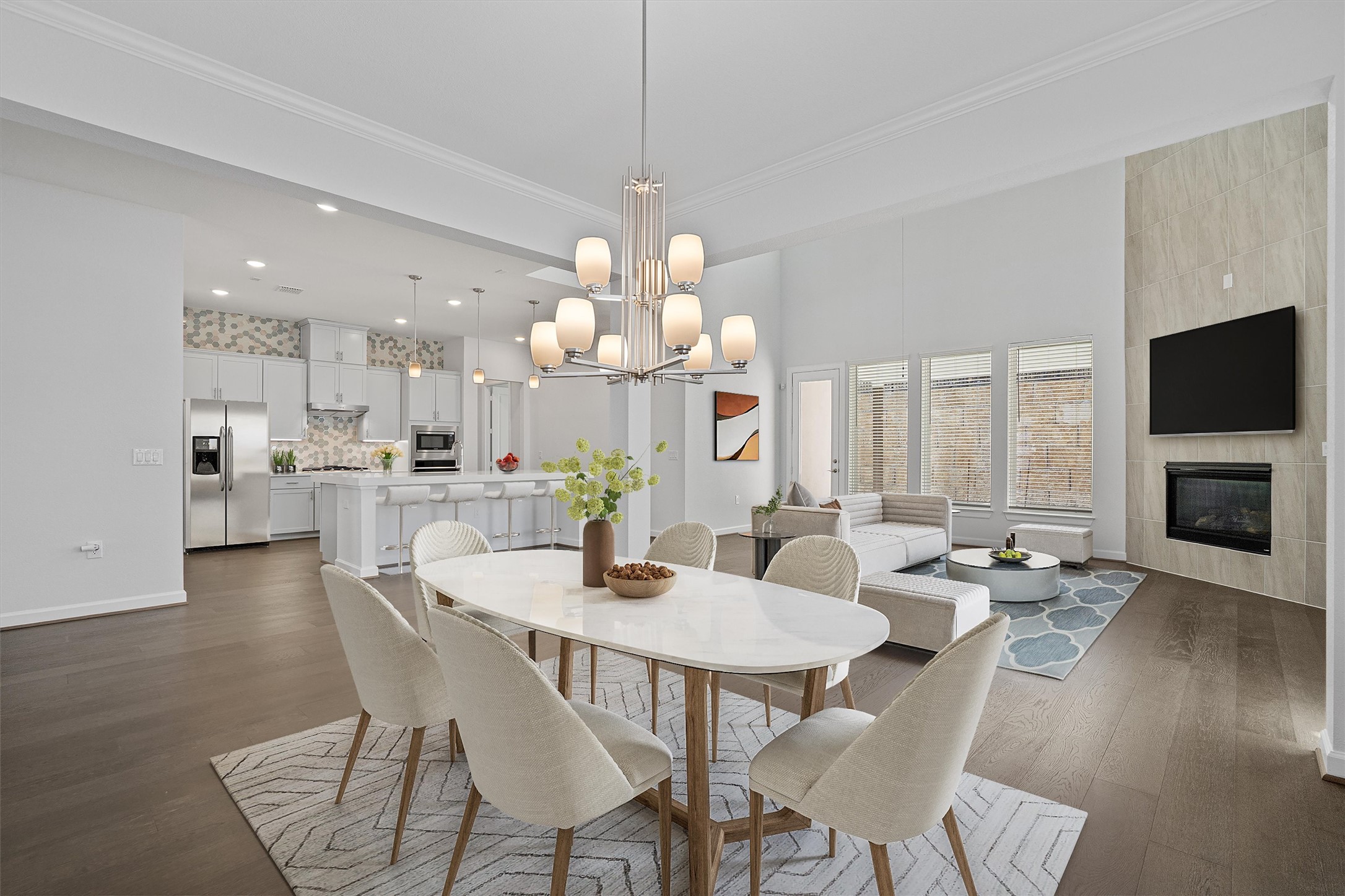 208 Lodestone Lane Austin, TX 78738 - Photo 9 of 38 Dining area featuring crown molding, dark wood-style flooring, a tiled fireplace, and hanging lights