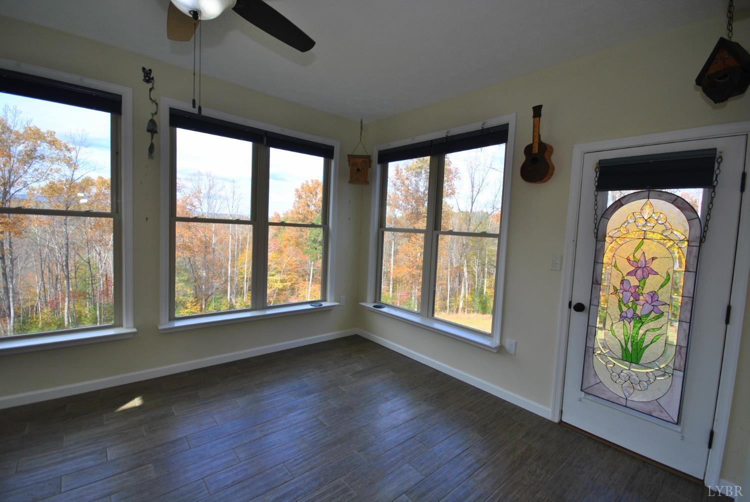 1206 East Perch Road Monroe, VA 24574 - Photo 15 of 83 an empty room with wooden floor and windows