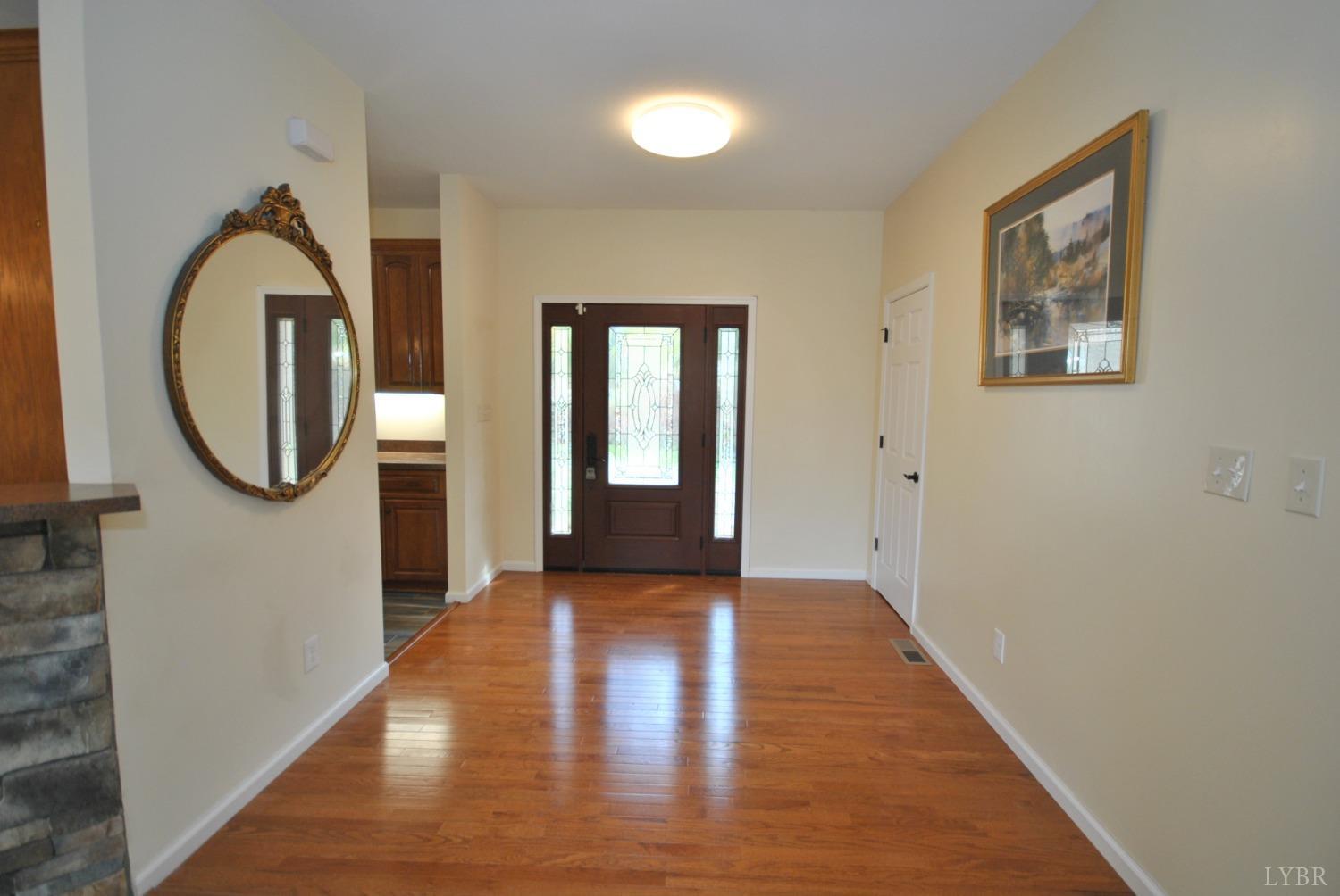 1206 East Perch Road Monroe, VA 24574 - Photo 8 of 83 a view of a hallway with wooden floor and a mirror