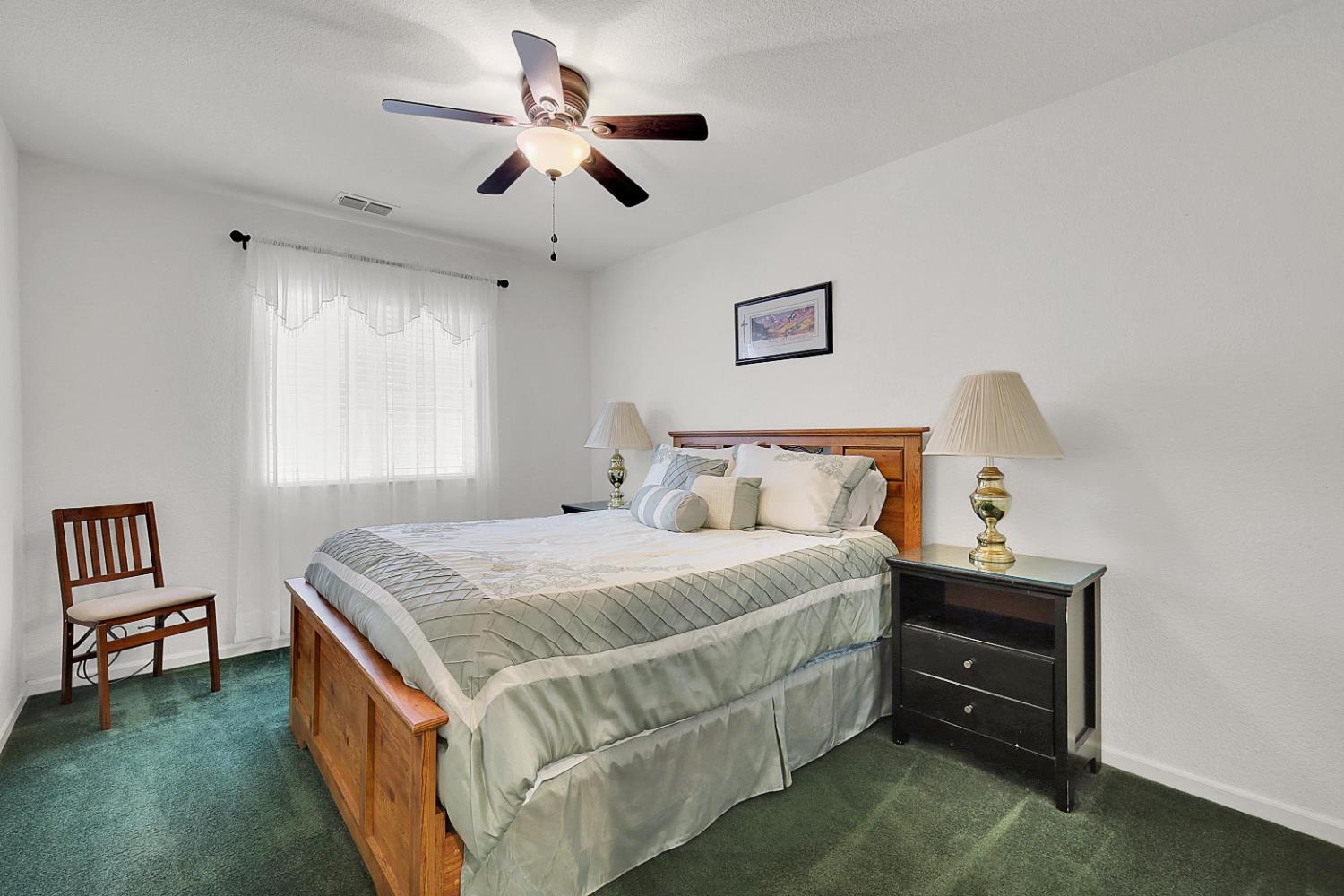 9840 Ellis Way Live Oak, CA 95953 - Photo 34 of 44 a bed room with a bed and a chandelier