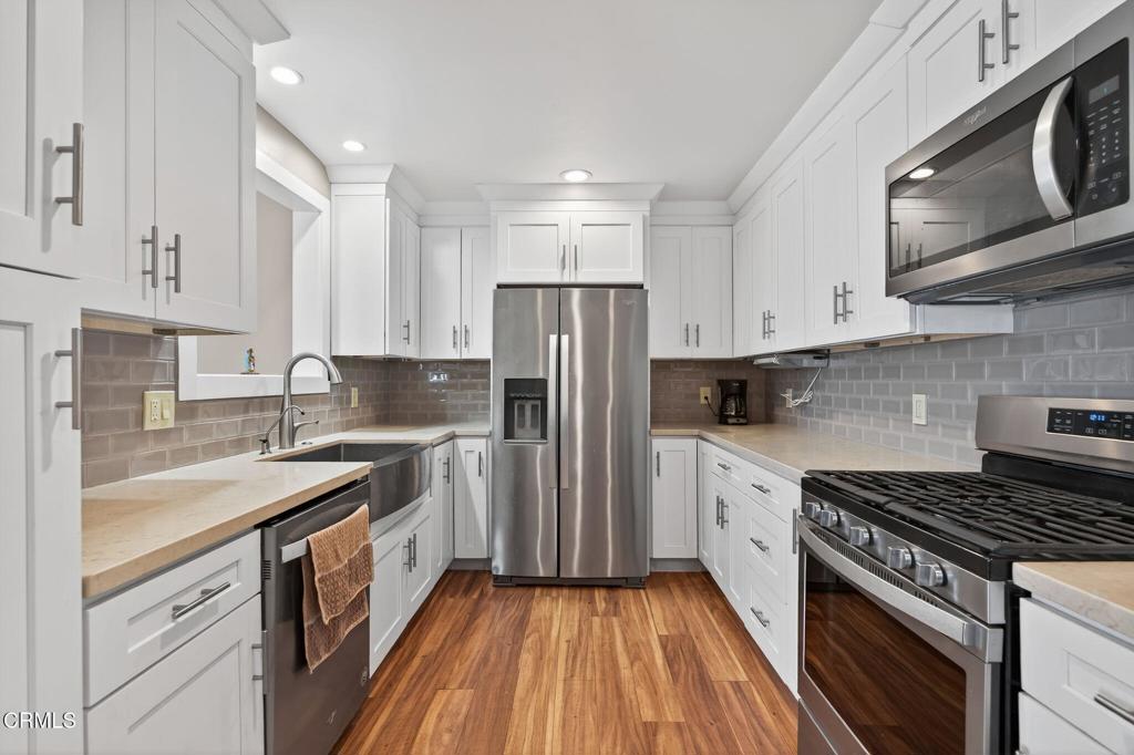 4029 South B Street Oxnard, CA 93033 - Photo 14 of 34 a kitchen with a sink stove and refrigerator