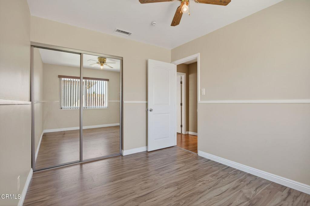4029 South B Street Oxnard, CA 93033 - Photo 26 of 34 an empty room with wooden floor and mirror