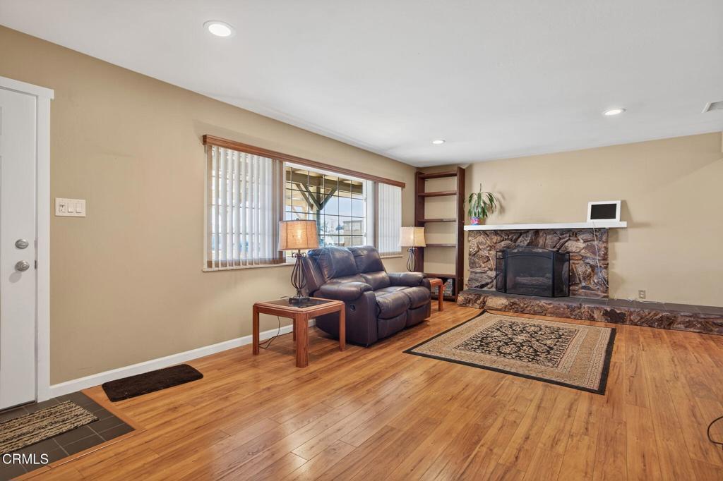 4029 South B Street Oxnard, CA 93033 - Photo 10 of 34 a living room with furniture and a fireplace