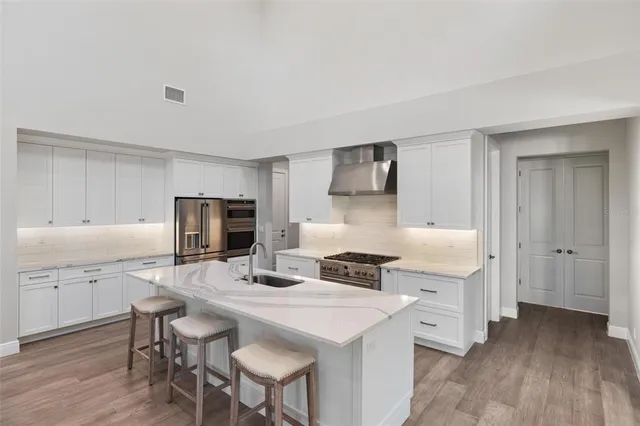 a kitchen with a sink cabinets and wooden floor