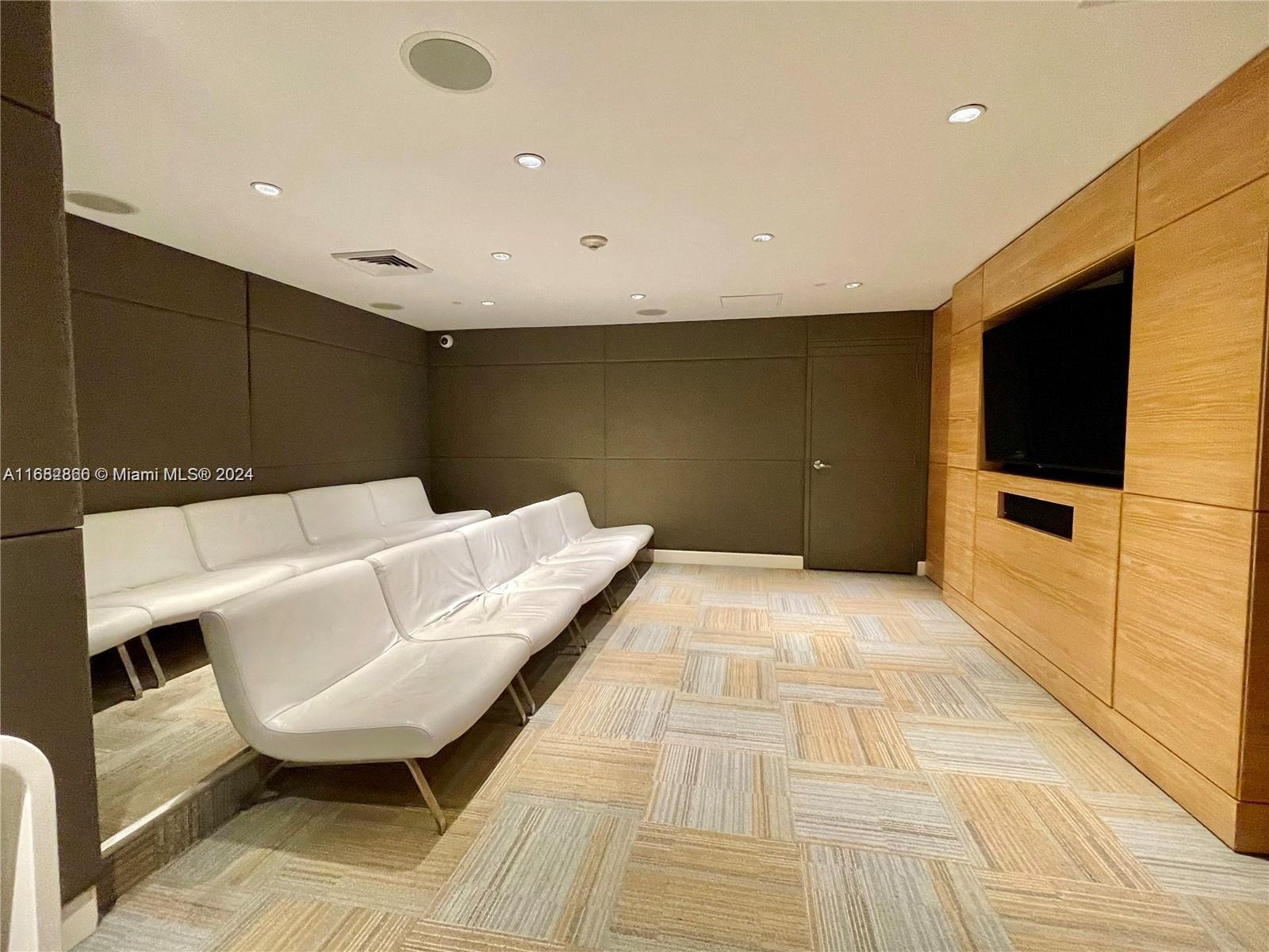 951 Brickell Avenue, Unit 3403 Miami, FL 33131 - Photo 11 of 26 a living room with a couch and a flat screen tv