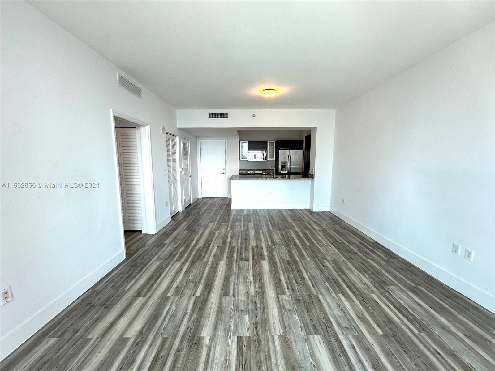951 Brickell Avenue, Unit 3403 Miami, FL 33131 - Photo 15 of 26 a view of a room with wooden floor
