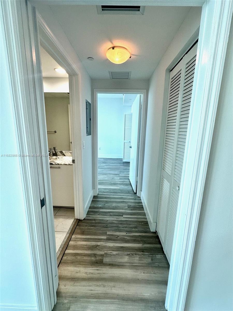 951 Brickell Avenue, Unit 3403 Miami, FL 33131 - Photo 16 of 26 a view of a hallway view with wooden floor and a bathroom