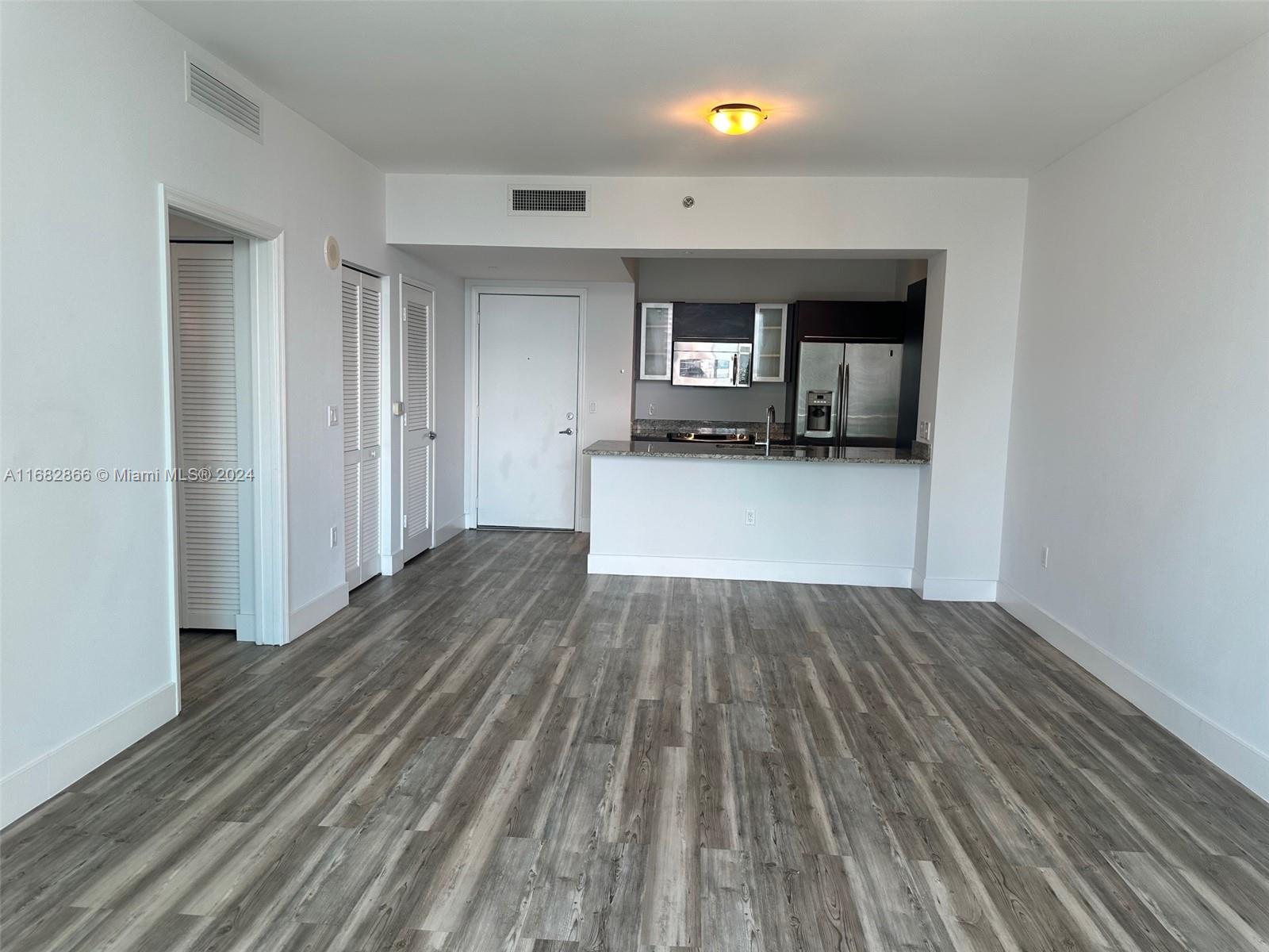 951 Brickell Avenue, Unit 3403 Miami, FL 33131 - Photo 26 of 26 a view of a kitchen with wooden floor and a sink