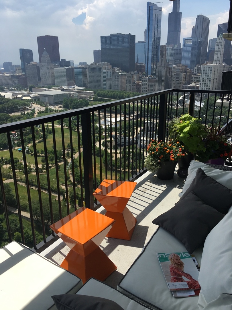 400 East Randolph Street, Unit 3405 Chicago, IL 60601 - Photo 14 of 17 a view of a balcony with two chairs and a table