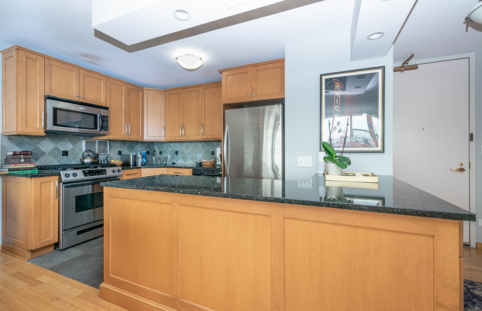 400 East Randolph Street, Unit 3405 Chicago, IL 60601 - Photo 4 of 17 a kitchen with stainless steel appliances granite countertop a refrigerator a stove top oven a sink and dishwasher