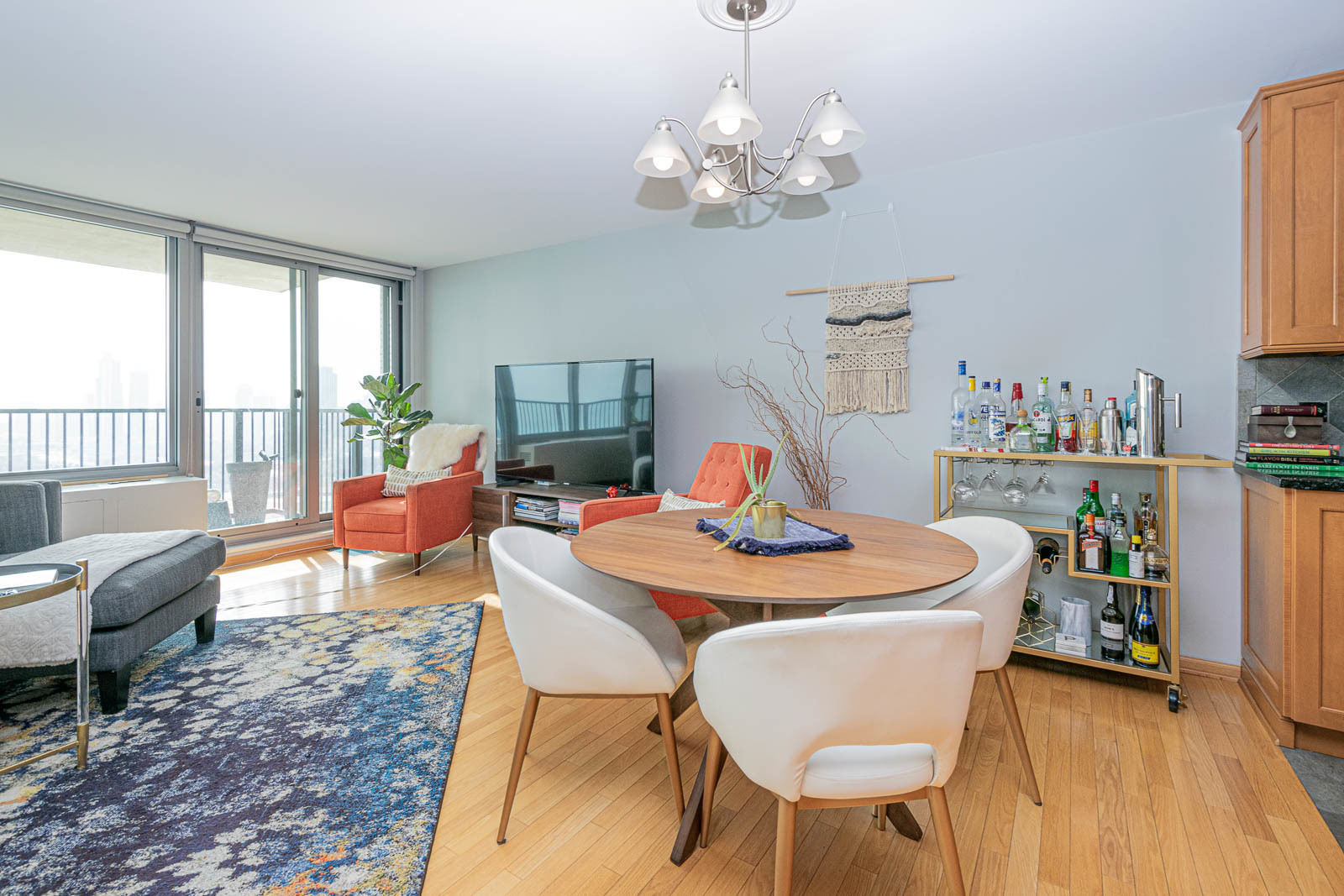 400 East Randolph Street, Unit 3405 Chicago, IL 60601 - Photo 7 of 17 a view of a dining room with furniture a chandelier and wooden floor