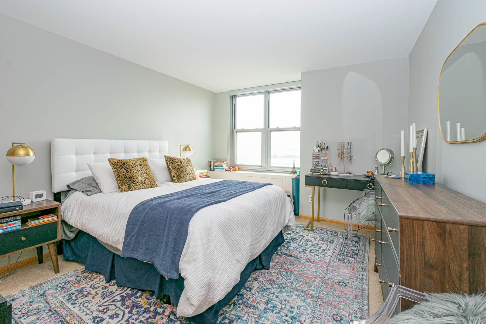 400 East Randolph Street, Unit 3405 Chicago, IL 60601 - Photo 8 of 17 a bedroom with a bed a table and three large mirror