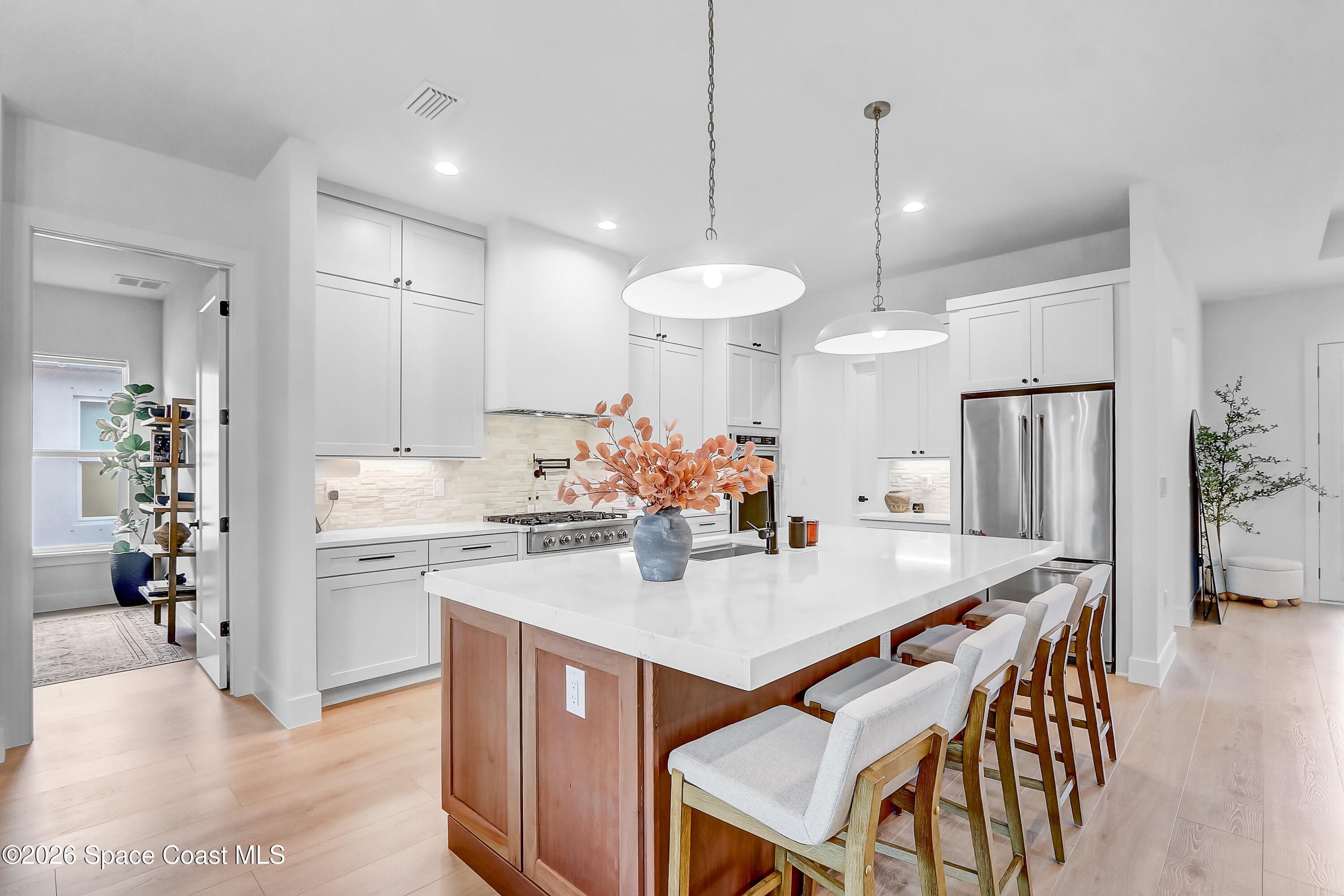 4225 Negal Circle Melbourne, FL 32901 - Photo 15 of 62 a kitchen with kitchen island a stove a dining table and chairs