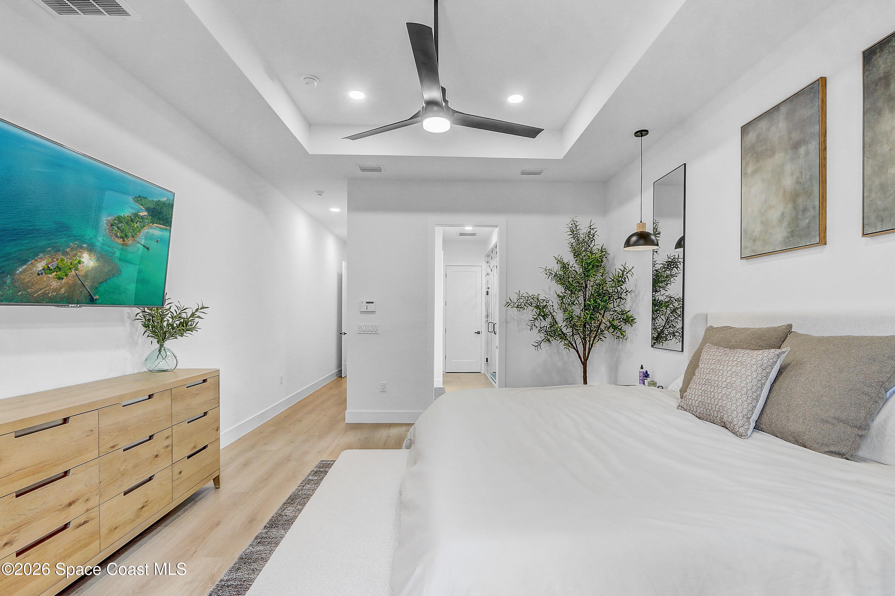 4225 Negal Circle Melbourne, FL 32901 - Photo 23 of 62 a spacious bedroom with a large bed and a dresser