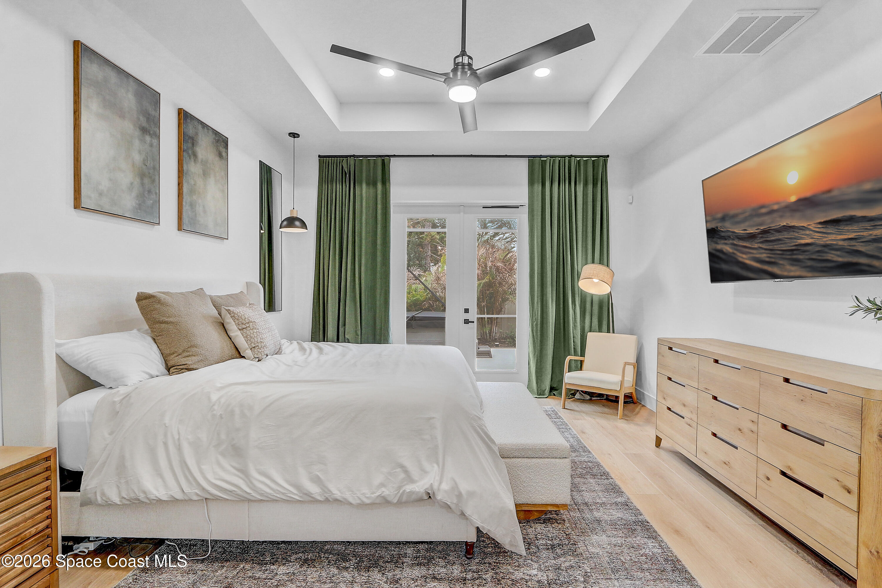 4225 Negal Circle Melbourne, FL 32901 - Photo 24 of 62 a bedroom with a large bed and a flat screen tv