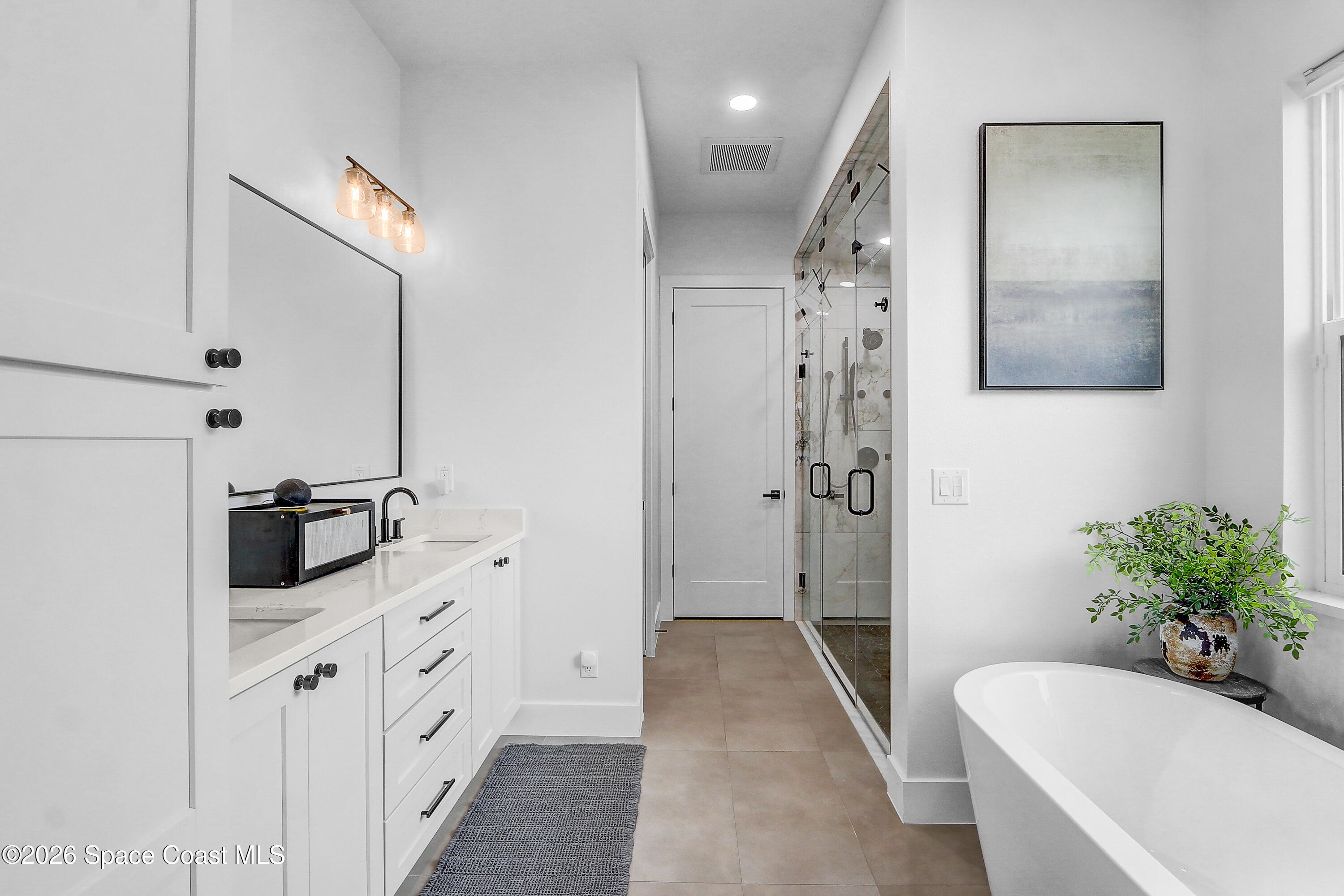 4225 Negal Circle Melbourne, FL 32901 - Photo 25 of 62 a bathroom with a tub sink and mirror