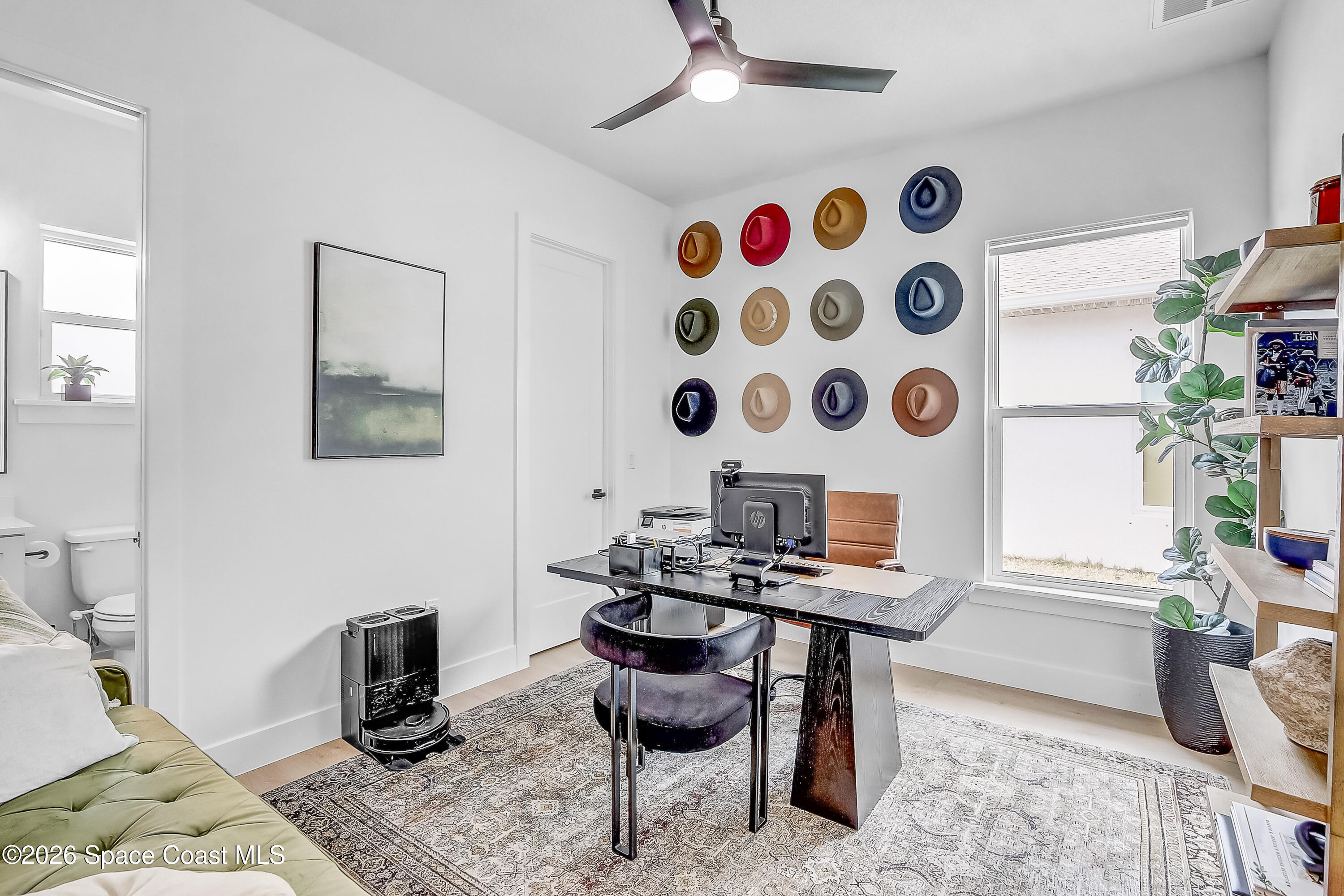 4225 Negal Circle Melbourne, FL 32901 - Photo 36 of 62 a view of a workspace with furniture and a potted plant