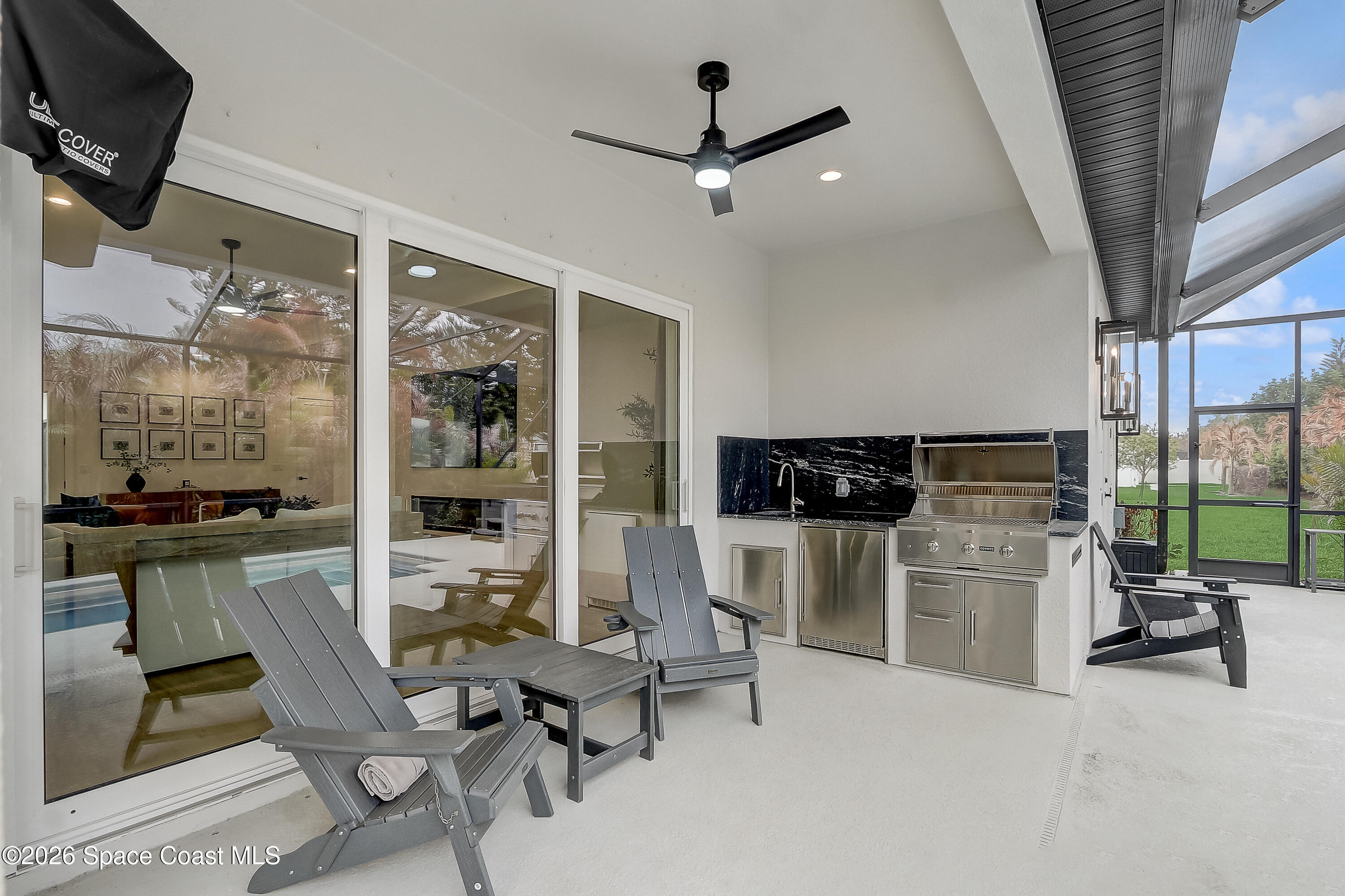 4225 Negal Circle Melbourne, FL 32901 - Photo 48 of 62 a living room with furniture a rug and kitchen view