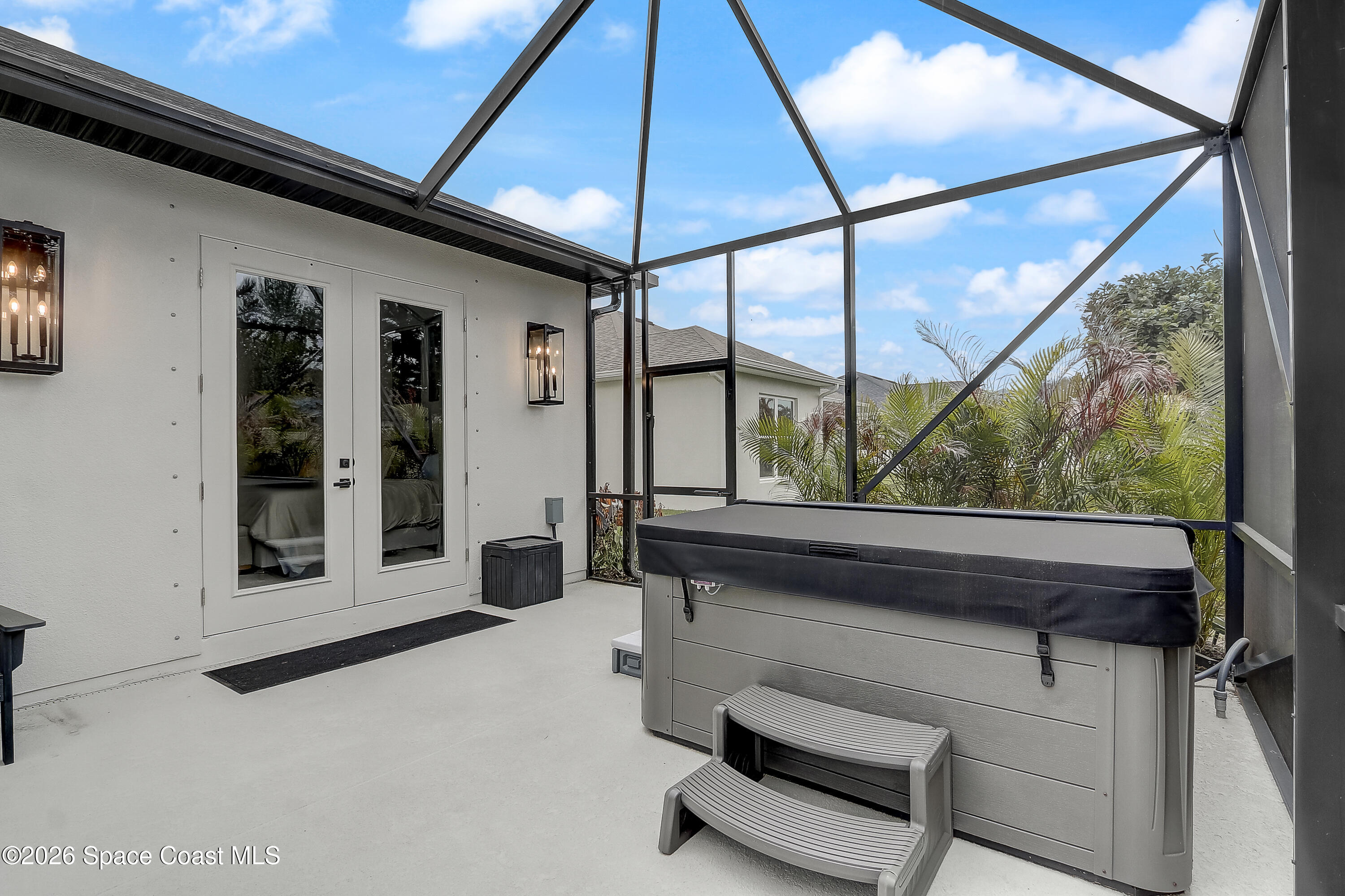 4225 Negal Circle Melbourne, FL 32901 - Photo 53 of 62 a view of a porch with furniture and floor to ceiling window