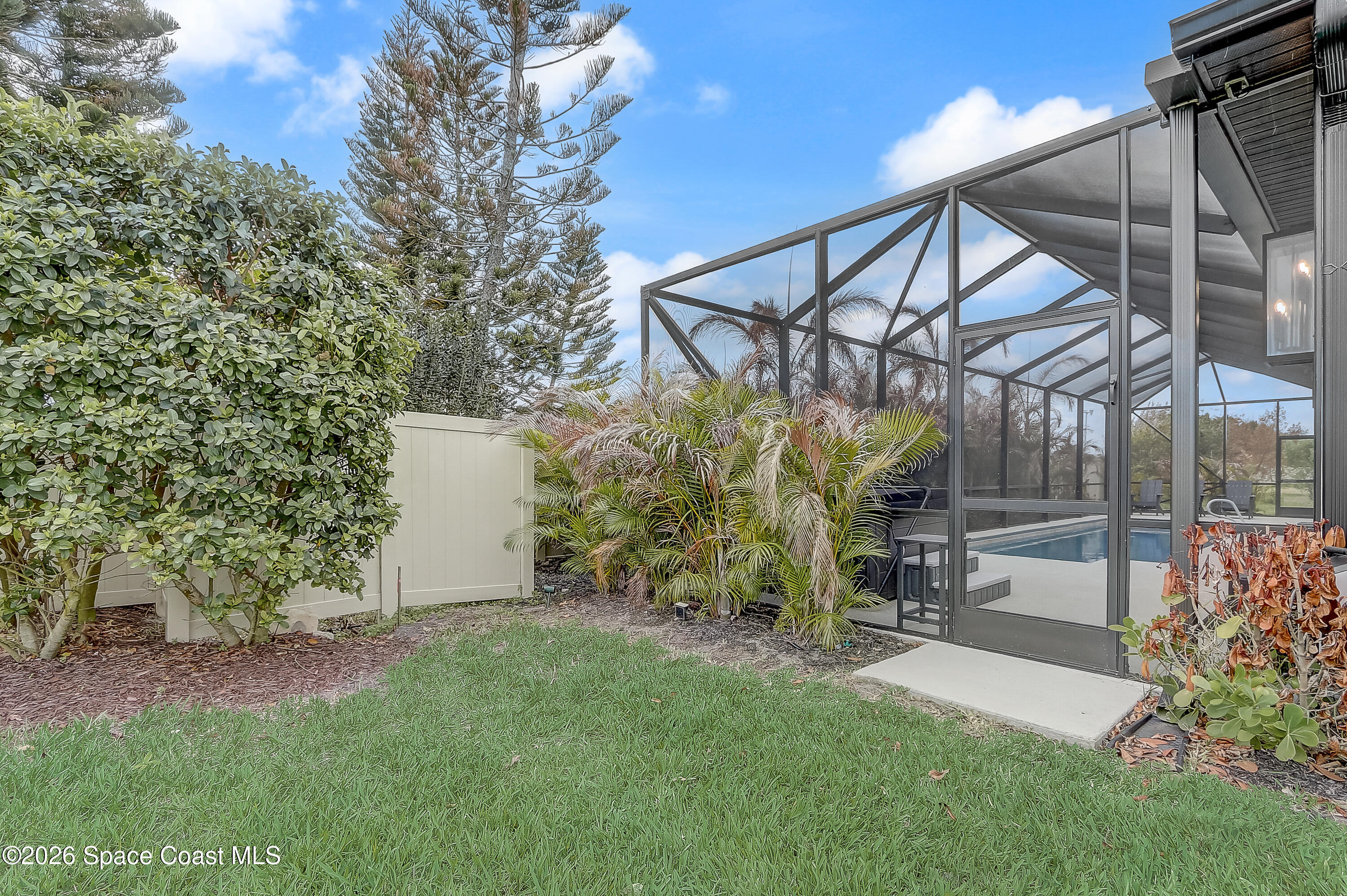 4225 Negal Circle Melbourne, FL 32901 - Photo 56 of 62 a view of a chair and table in backyard of the house