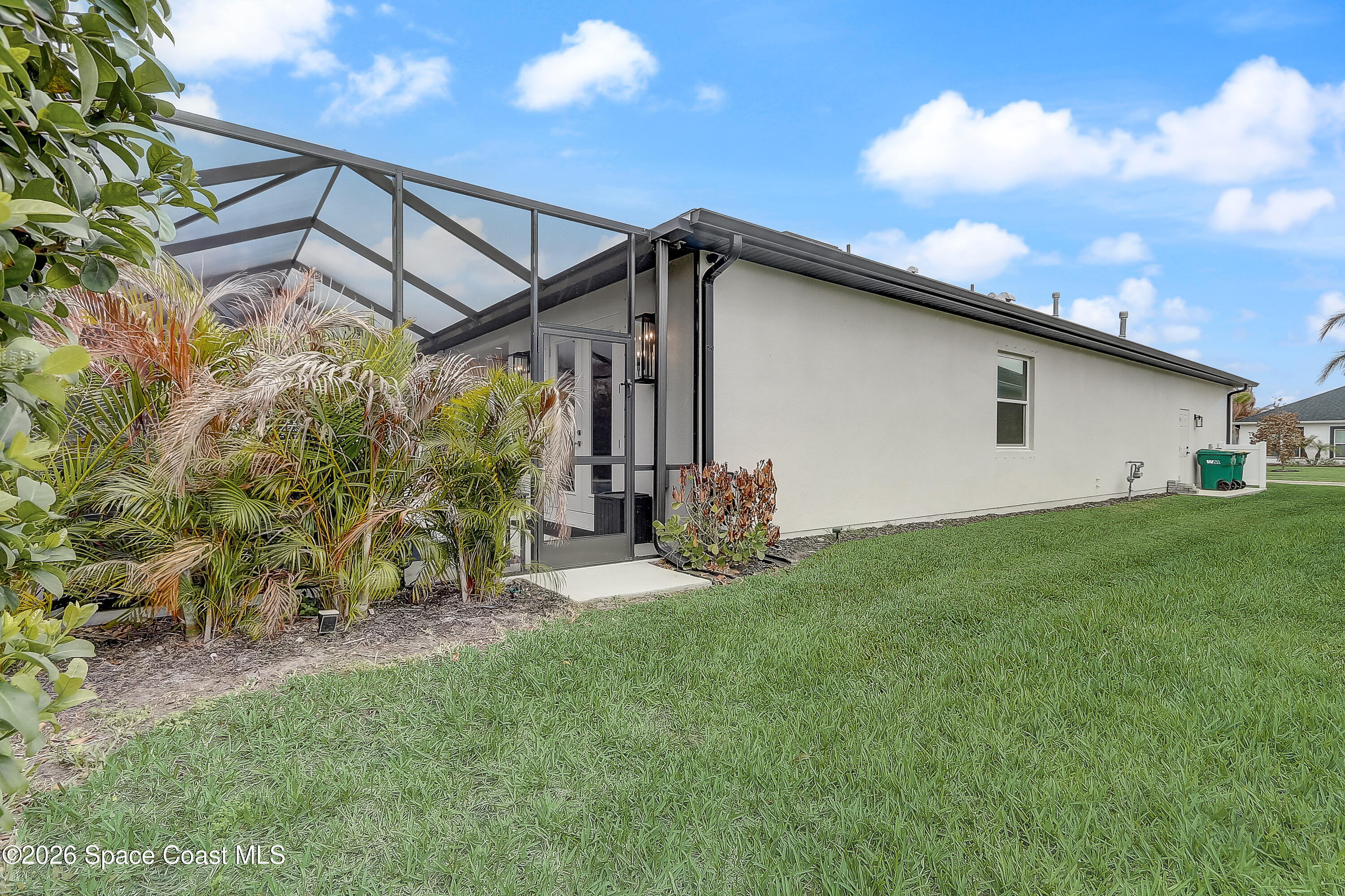 4225 Negal Circle Melbourne, FL 32901 - Photo 57 of 62 a view of a backyard with plants and a patio